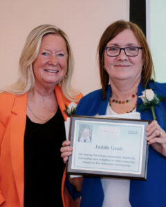 Karen Phelps and another woman from the organization Partnering Aldershot receiving and award. 