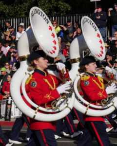 Two female Tuba players marching in a parade with the Burlington Teen Tour Band, 