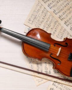 a violin with sheet music and a bow.